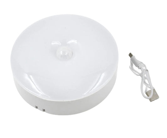 White round electronic device with a USB cable on a white background