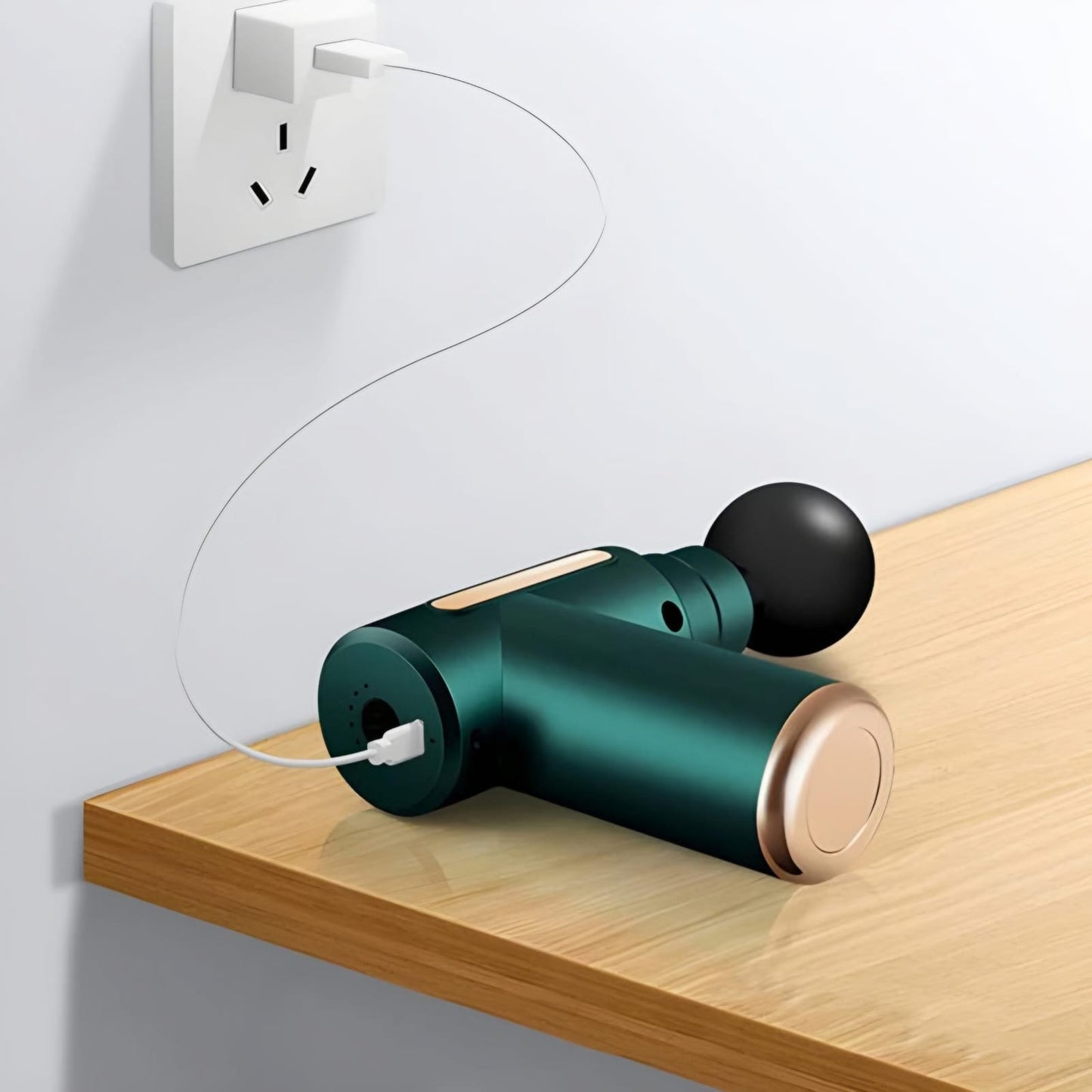 Green and gold cylindrical device plugged into a wall socket on a wooden surface.